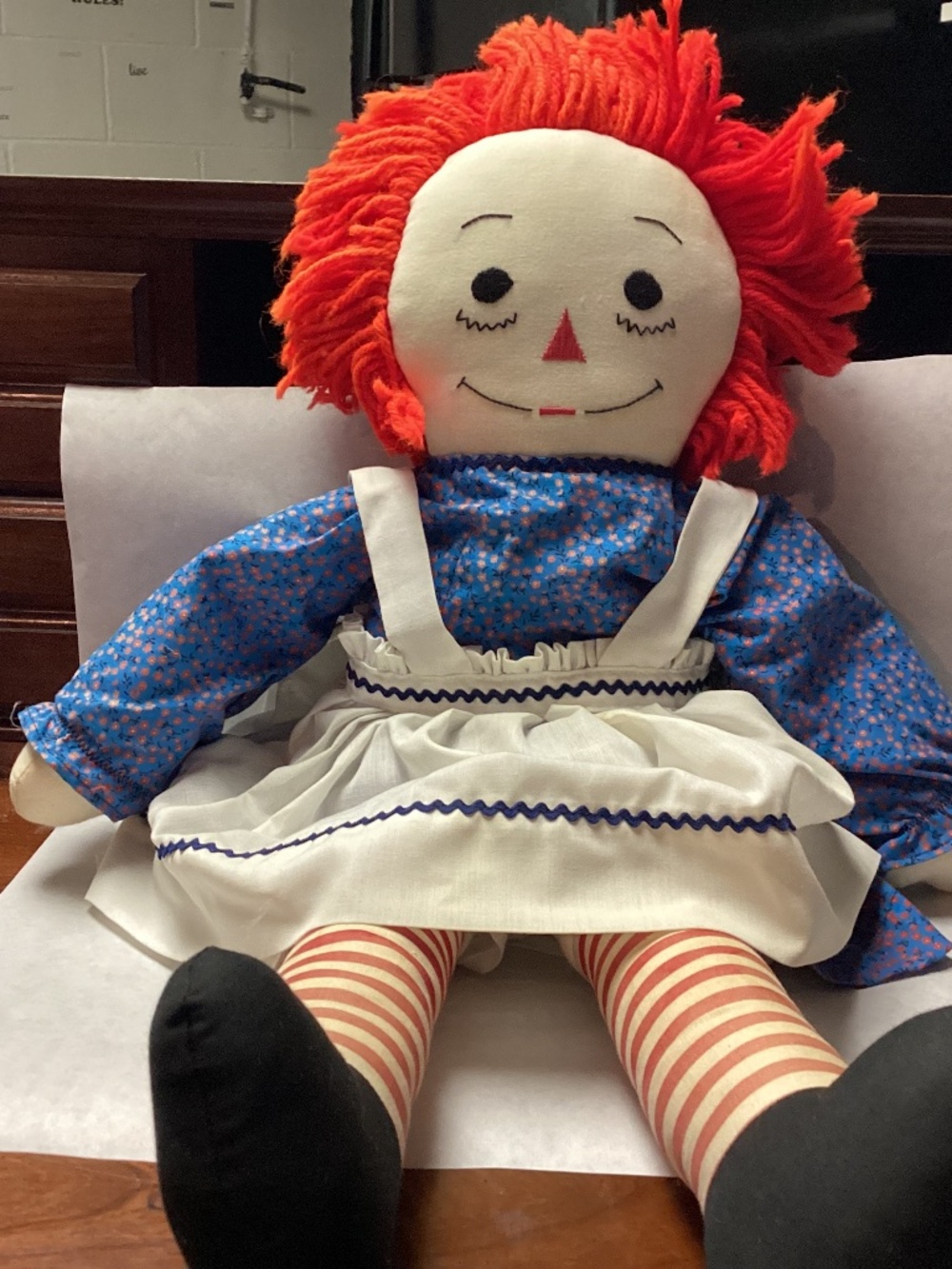 Large raggedy Ann doll dressed meticulously stored